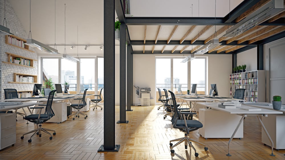 Modern open-plan office with desks and windows