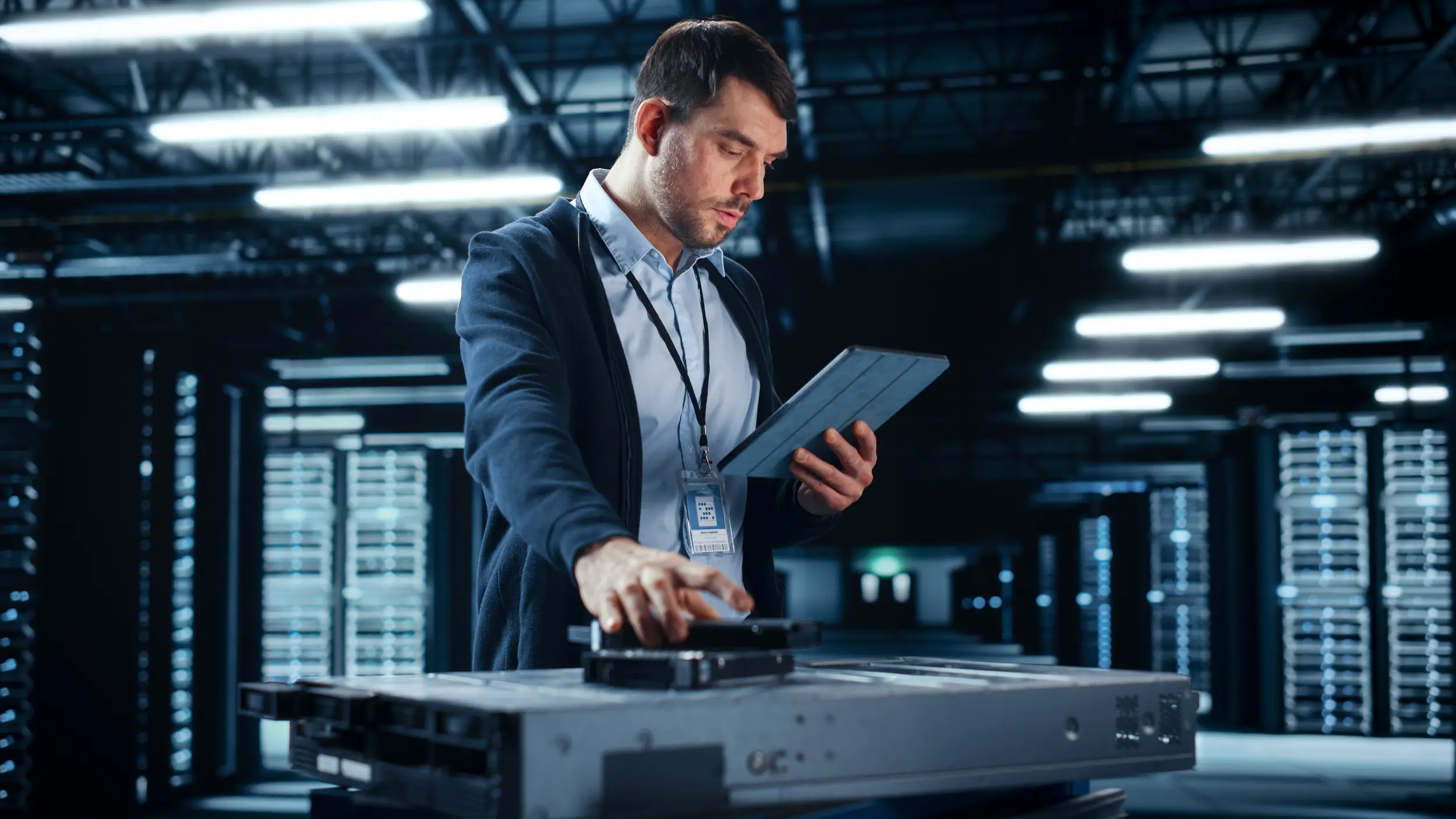 Technician working on server in data center.