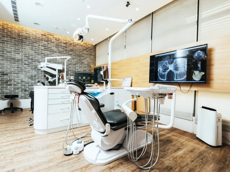 Modern dental office with equipment and displays.